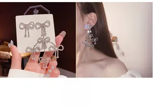 Detailed view of silver bow-knot long tassel earrings with sparkling rhinestones and S925 pin