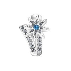 Macro shot of silver eight-point star earring with blue crystal and white zirconia inlay