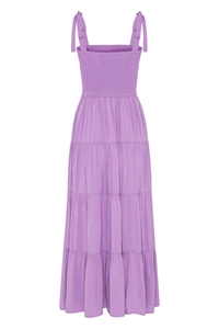Detail of purple tier dress with smocked bodice and textured polka dot fabric