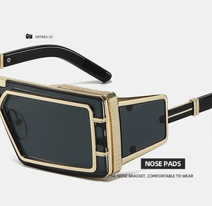 Macro detail of comfortable silicone nose pads on black and gold futuristic square sunglasses