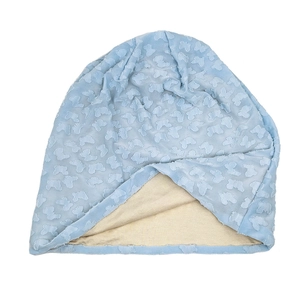 Detail of light blue slouchy beanie featuring a textured floral lace butterfly pattern