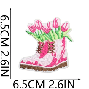 Detail view of pink boot-shaped embroidery patch with tulips and 6.5cm size markings