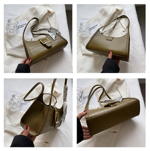 Detail view of olive green shoulder bag with crocodile texture, gold buckle and silk scarf