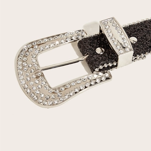 Close-up of Y2K black glitter belt featuring a large silver buckle with sparkling rhinestones