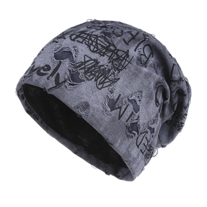 Distressed dark grey knit beanie with black graffiti lettering and punk style holes