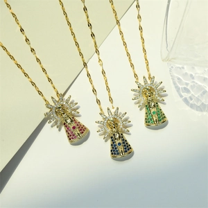 Detailed view of three gold crown pendants with vibrant red blue and green crystals