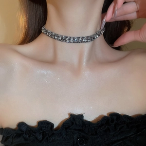 Close-up of elegant silver collar necklace with cubic zirconia on model's neckline