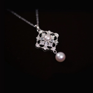 Elegant silver necklace with rhombic flower design, zircons and white pearls on black background