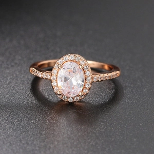Classic oval halo engagement ring in rose gold with shimmering cubic zirconia accents