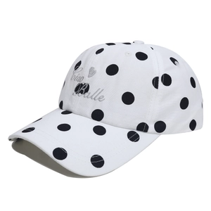 Detail of white polka dot baseball cap featuring Ciao Balle embroidery and heart pattern