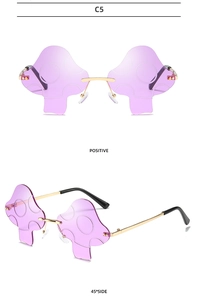 Detail view of purple mushroom-shaped rimless sunglasses with gold metal frame