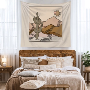 Detail showing bohemian wall tapestry with desert landscape line art in a cozy bedroom