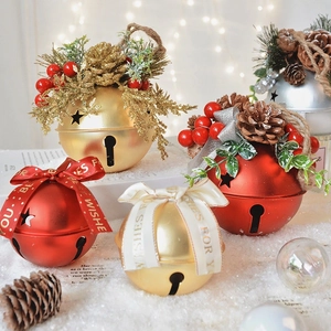 Christmas metal bells with pine cones and red ribbon on snow background