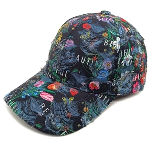 Close-up of floral denim baseball cap featuring distressed edges and white text print