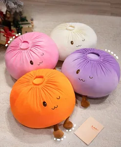 Detailed view of colorful plush bun pillows with cute embroidered faces on soft carpet