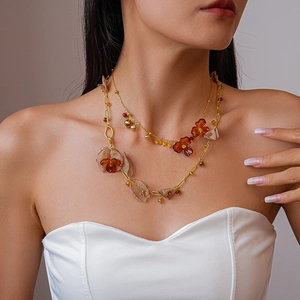 Detail of vintage acrylic chiffon flower necklace on model showing elegant layering