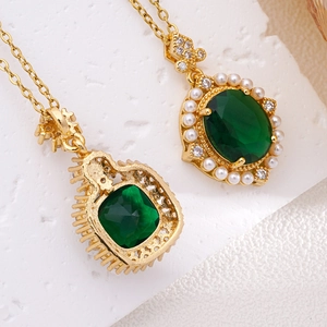 Vintage 18K gold necklace with emerald gemstone pendant and pearl accents on white background