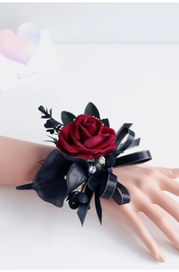 Détail d'un corsage de poignet de mariage avec rose rouge, calla noir et strass