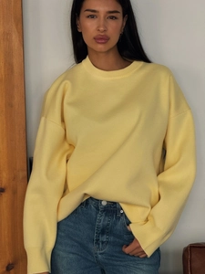 Minimalist light yellow crewneck knit sweater in a loose silhouette and dropped shoulders