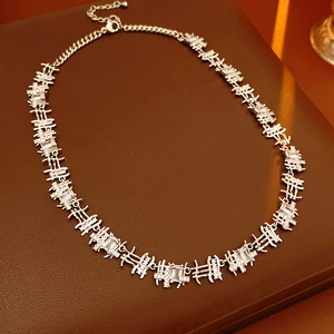 Close-up of silver zircon square chain necklace on premium brown leather surface