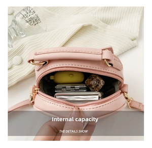 Detail view showing the spacious interior storage of this pink crossbody bag