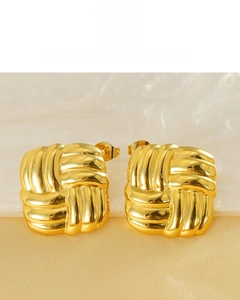 Detail of 18k gold plated square earrings featuring a woven texture and glossy finish