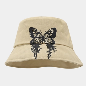 Detailed close-up of butterfly print with water ripple effect on beige cotton bucket hat