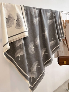 Detail of double-sided ginkgo leaf pattern scarf with soft fringes and elegant drapes