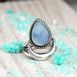 Macro shot of retro silver ring with pear-shaped blue stone and crescent moon detail