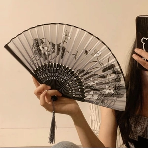 Detail of folding fan featuring lotus ink painting and black hollowed bamboo frame