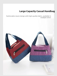 Detail view of contrast color lunch bags with reinforced webbing handles and front pocket