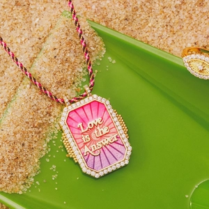 Gold octagon tarot pendant with pink enamel Love is the Answer on a braided rope