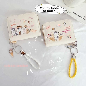 Close-up of cute cartoon cat wallet with woven handle pendant and metal keyring