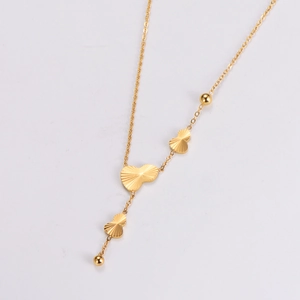 Macro shot of gold butterfly pendant tassel necklace with elegant Y-shaped chain design