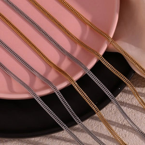 Close-up of gold and silver 3mm foxtail woven chains on a decorative plate