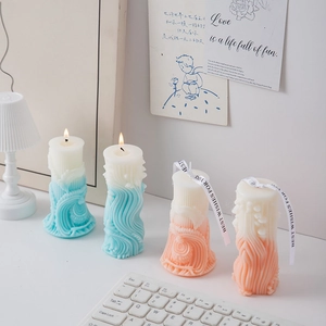 Macro detail of geometric roman column scented candles with wavy texture and ribbon bows