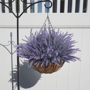 Artificial purple lavender in a coco liner hanging basket with black metal heart frame