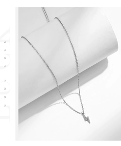 Macro shot of minimalist S925 sterling silver lightning bolt necklace with zircon stones