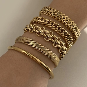 Gold stainless steel bracelet set with snake chain and cuff on model wrist