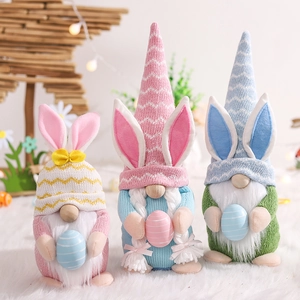 Three Easter Gnomes set with bunny ears and colorful eggs for festive home decoration