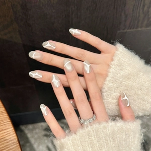 Elegant champagne gold cat-eye press-on nails with white artistic line art design