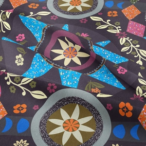 Detailed macro view of bohemian mandala tapestry fabric with intricate floral patterns