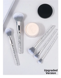 Detail of 5 makeup brushes featuring sparkling diamond filled handles and soft gradient bristles