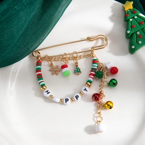 Détail de la broche de Noël avec perles HAPPY, cloches et pompons sur épingle dorée