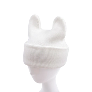 Detailed close-up of white knit beanie featuring cute cat ear design on a minimalist base