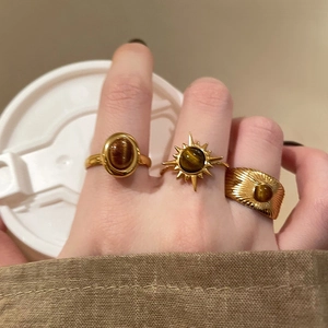Bohemian gold plated rings set with tiger eye stone and brushed texture on hand