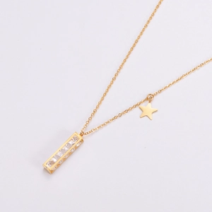 Detail of gold rectangular pendant with zircons and a minimalist star charm