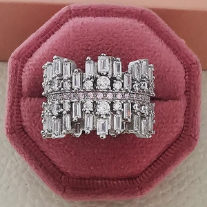 Macro shot of luxury zircon ring with pink stones in a velvet hexagon jewelry box