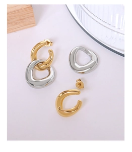 Macro detail of French style twisted double loop earrings in gold and silver finish