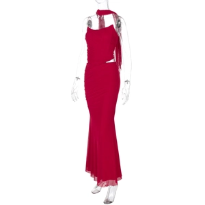 Detail of red halter maxi dress featuring waist cut-out and matching long neck scarf